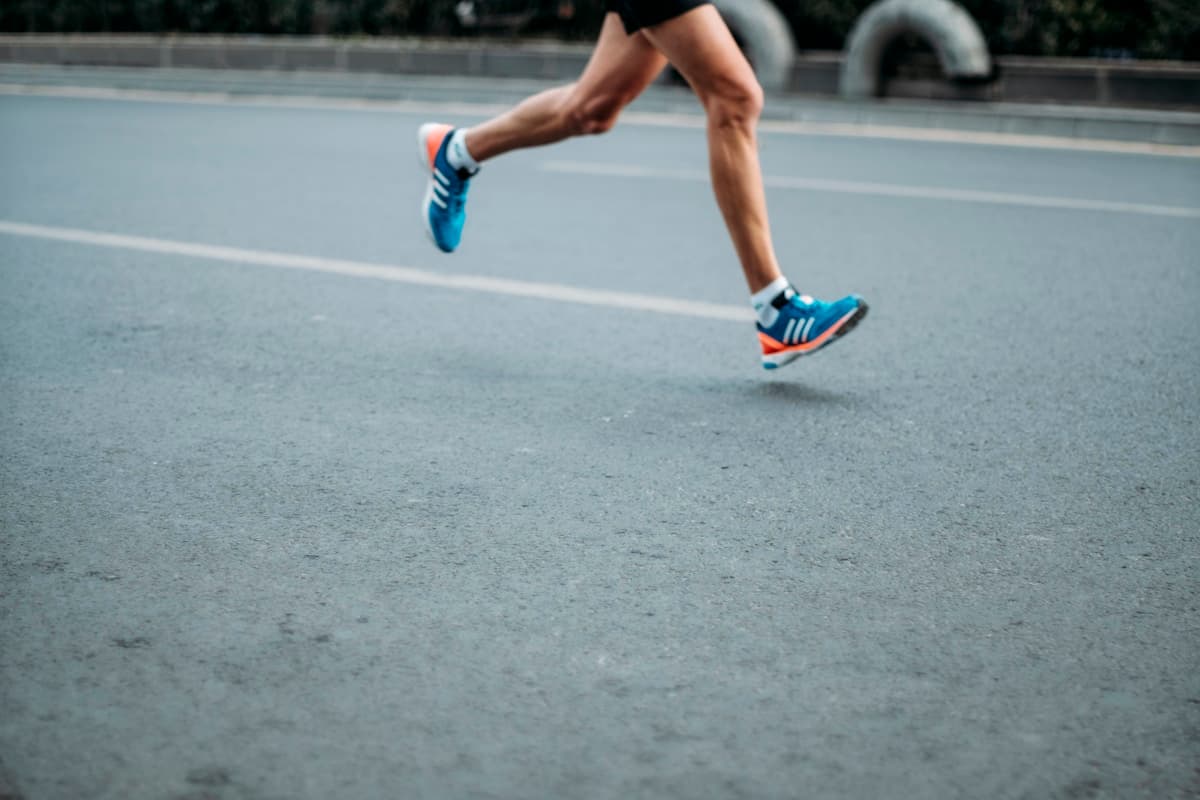 Runner in motion wearing carbon plate running shoes
